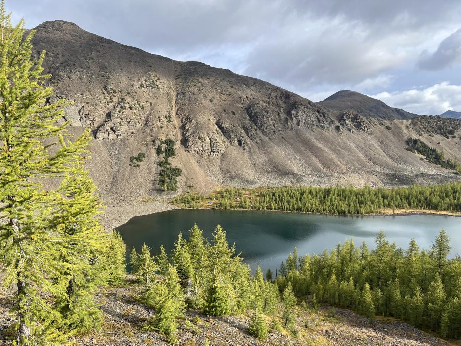 Exploration camp setting with lake and mountains in background at the Findlay Project of Southeast BC