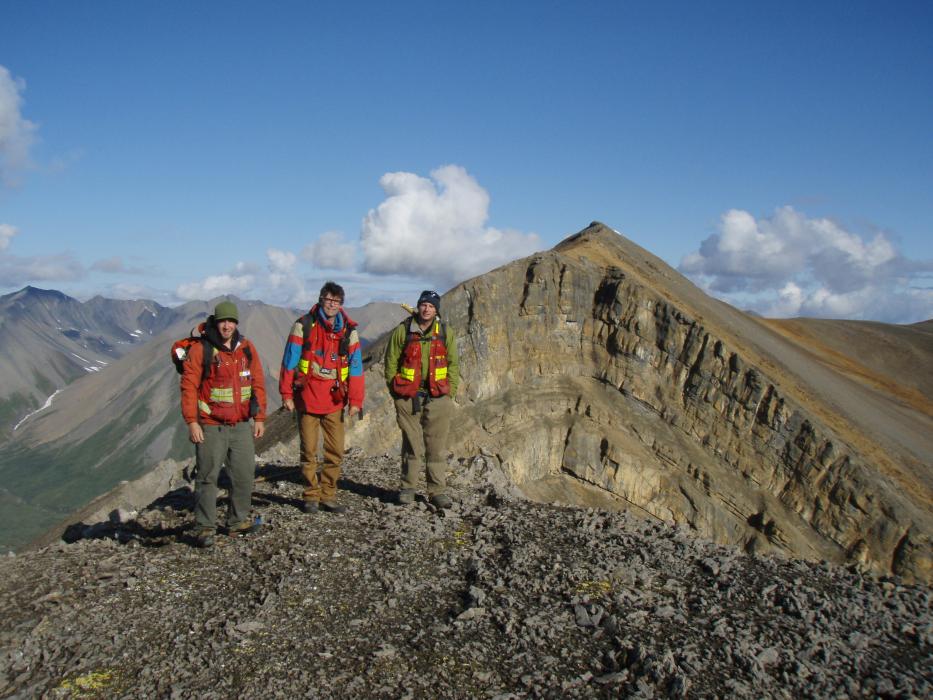 Geologist posing in the foreground of a huge fold in the Mackenzie Mountains